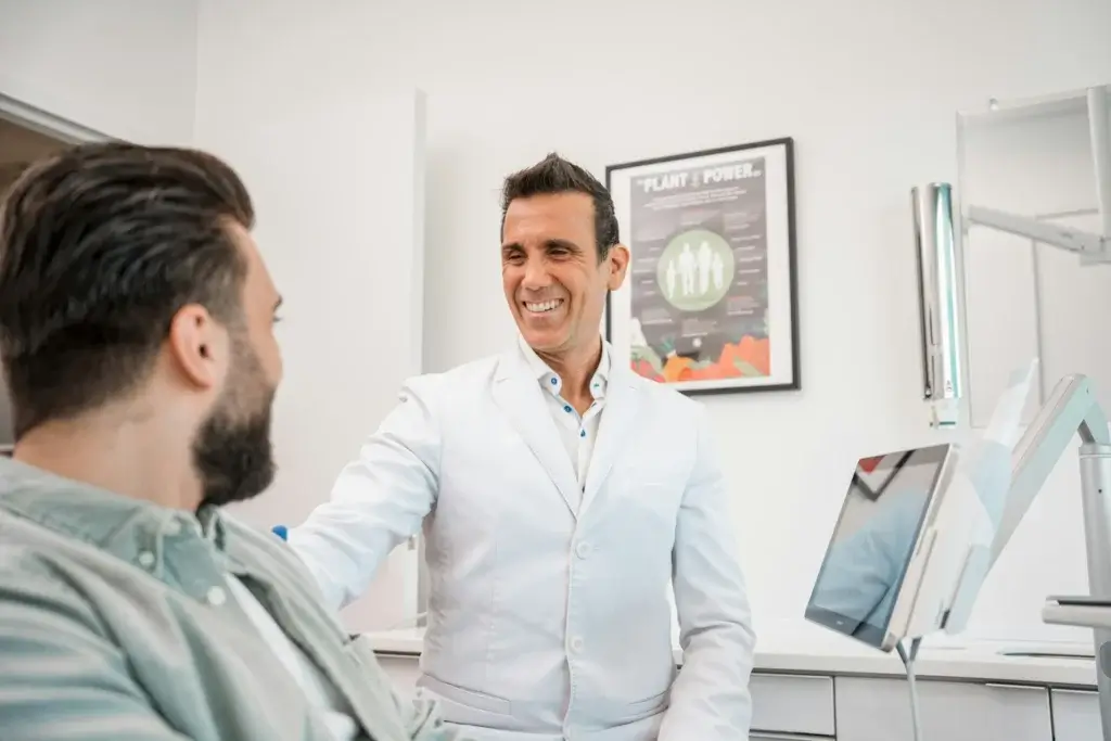 A dentist looking fondly at his patient after the appointment because he has such great teeth.